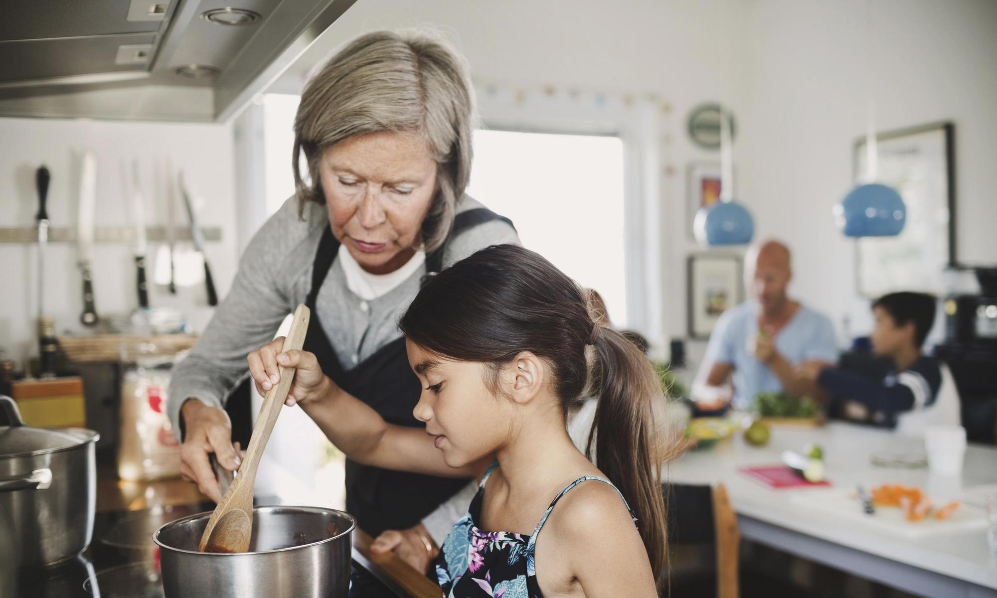 Grandmother and grandchild cooking together